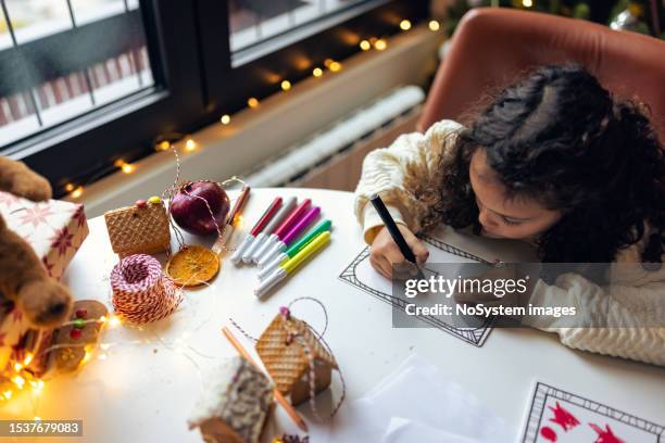 cute little kid writing letter to santa claus - december 6 stock pictures, royalty-free photos & images