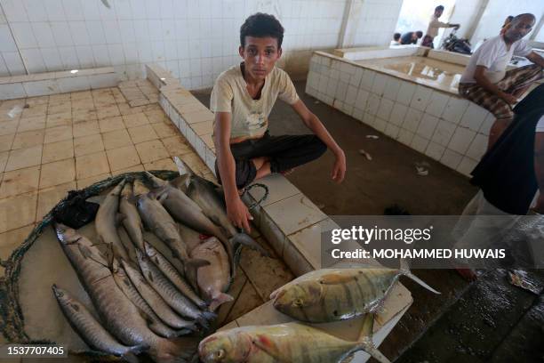 Fishermen bring their catch to sell at a fish market in the embattled Red Sea port city of Hodeida on July 16, 2023.