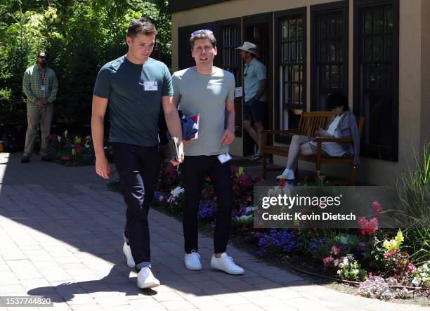 Sam Altman , CEO of OpenAI, and Ollie Mulherin, Australian software engineer, walk from lunch at the Allen & Company Sun Valley Conference on July...