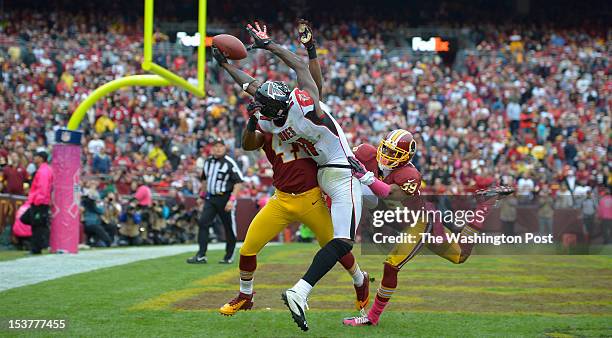 Washington's free safety Madieu Williams (41, left, and Washington's cornerback Richard Crawford defends as Atlanta's wide receiver Julio Jones fails...