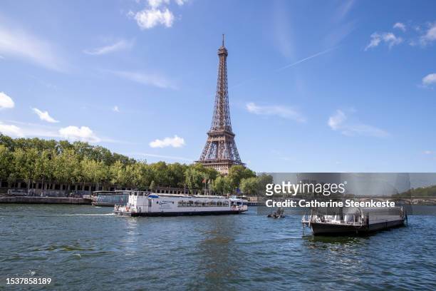 An empty boat travels the river Seine during the technical test event for the Paris 2024 opening ceremony with the Eiffel Tower in the background on...