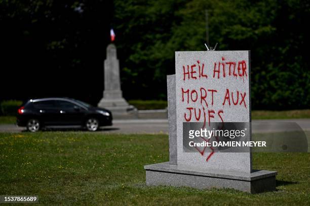 This picture taken on July 17, 2023 shows a graffito in German and French reading "Hail Hitler, death to jews" and with a swastika, on a monument in...