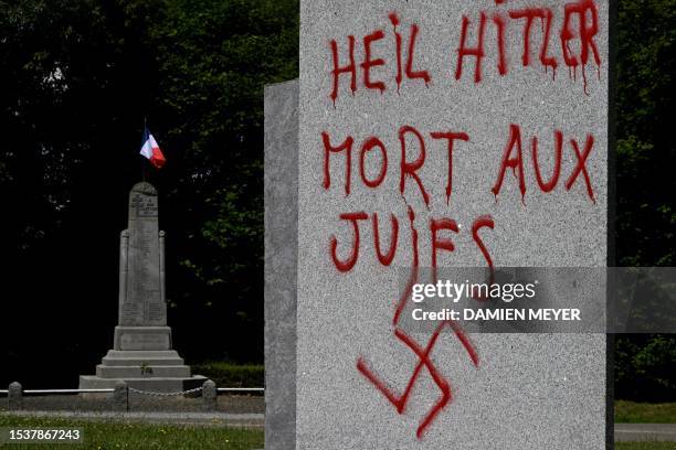 This picture taken on July 17, 2023 shows a graffito in German and French reading "Hail Hitler, death to jews" and with a swastika, on a monument in...