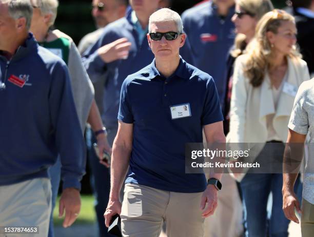 Tim Cook , CEO of Apple, walks with fellow attendees as they leave a morning session at the Allen & Company Sun Valley Conference on July 12, 2023 in...