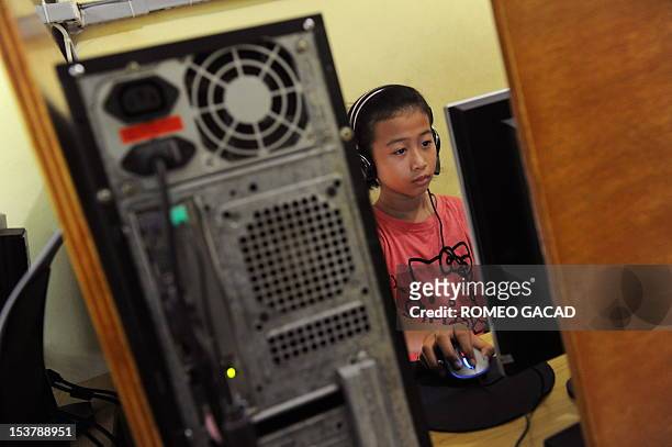 Vinna Erviliana, 12-year-old Indonesian teenage girl goes online on Facebook at an Internet shop in Jakarta on June 17, 2010. Indonesia's...