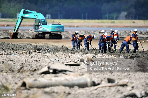 Police officers search missings at the Nagatsura area, on October 8, 2012 in Ishinomaki, Miyagi, Japan. The 224 hectare area, had sunk under the...