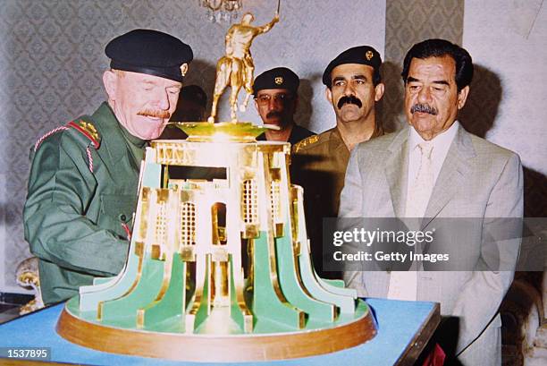 Vice-chairman of the Revolutionary Command Council Izzet Ibrahim presents Iraqi President Saddam Hussein with a gift from the people of Mousl...