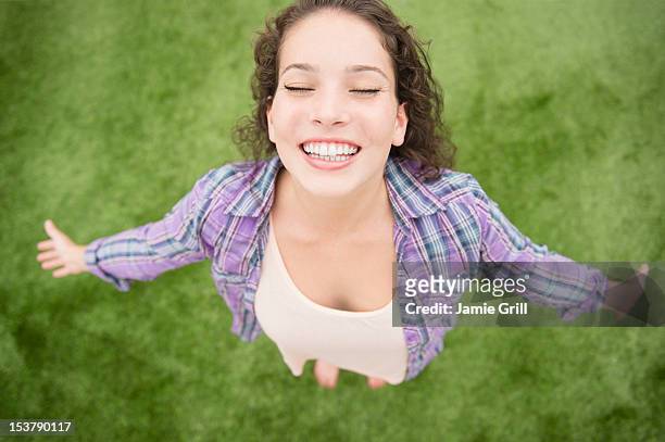 teenage girl with arms outstretched, outside - happy woman arms raised stock pictures, royalty-free photos & images