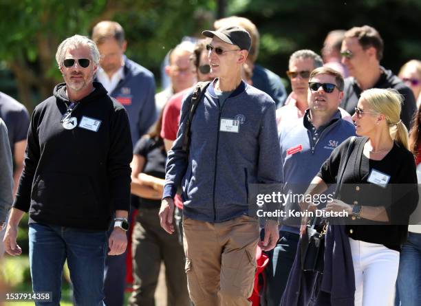 Casey Wasserman, Chair of the Wasserman Media Group, Adam Silver, Commissioner of the NBA, and Jenny Chandler leave a morning session at the Allen &...