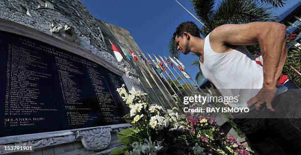 Bali bombing survivor, Australian Phil Britten, looks at the names of dead victims at a memorial monument three days before a commemoration ceremony...