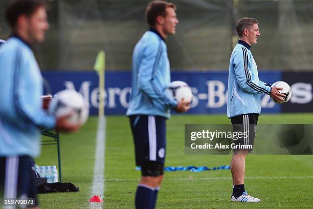 Bastian Schweinsteiger, Holger Badstuber and Heiko Westermann attend a Germany training session ahead of their FIFA 2014 World Cup group C qualifying...