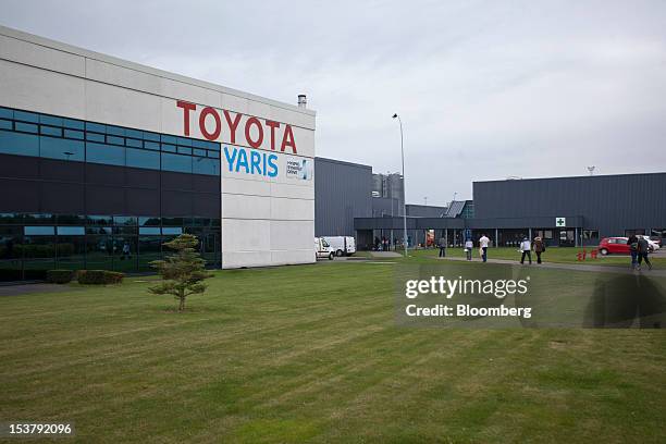 Employees arrive at the Toyota Motor Corp. Factory in Onnaing, France, on Monday, Oct. 8, 2012. PSA Peugeot Citroen needs to discuss with the...