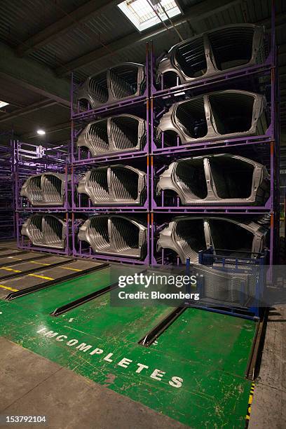 Body parts for Toyota Motor Corp. Yaris automobiles are seen stacked on racks at the company's factory in Onnaing, France, on Monday, Oct. 8, 2012....