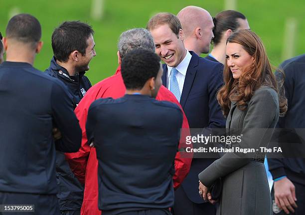 Prince William, Duke of Cambridge and Catherine, Duchess of Cambridge speak with the England team during the official launch of The Football...