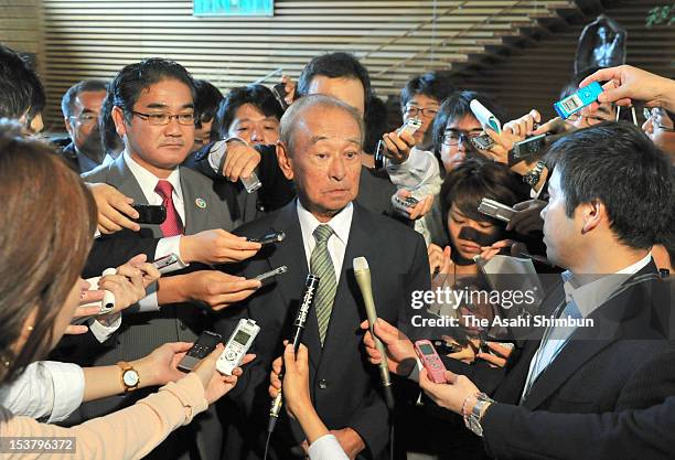 Okinawa prefecture governor Hirokazu Nakaima speaks to the media reporters while Ginowan City Mayor Atsushi Sakima looks on after their meeting with...