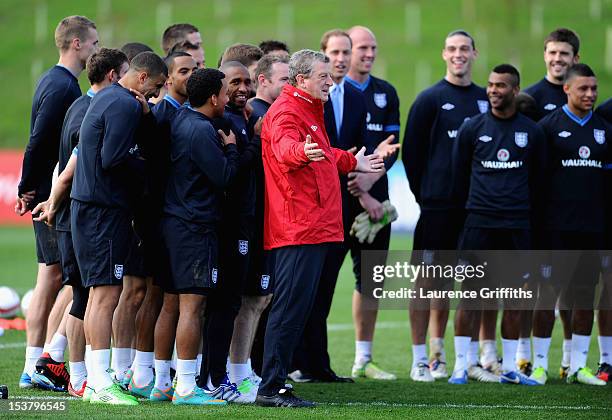 England Manager Roy Hodgson conducts a group photograph with Prince William, Duke of Cambridge and Catherine, Duchess of Cambridge as they visit a...