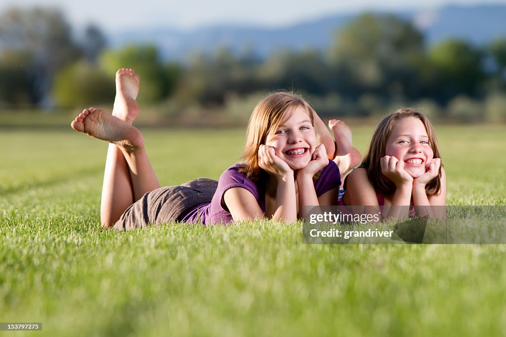 Two cute girls posing in a field