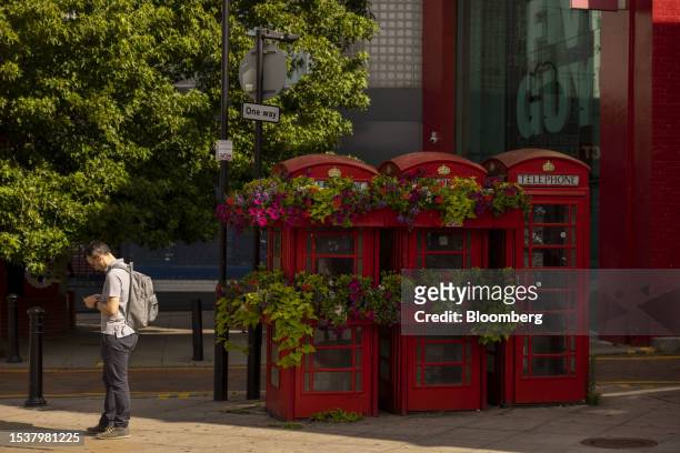 Row of traditional red British phone boxes decorated with flowers in Uxbridge in London, UK, on Monday, July 17, 2023. The looming by-election for...