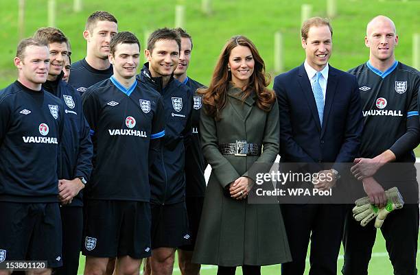 Prince William, Duke of Cambridge and Catherine, Duchess of Cambridge pose with the England team during the official launch of The Football...