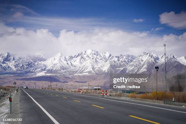 snow mountain background highway in pamir mountains,empty asphalt road with snow mountain - karakoram bildbanksfoton och bilder