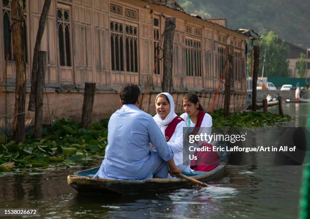 Kashmiri girls going to school by boat, Jammu and Kashmir, Srinagar, India on June 12, 2023 in Srinagar, India.