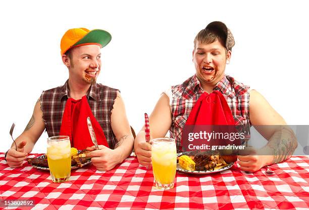 two young men red necks eating barbeque - redneck stock pictures, royalty-free photos & images