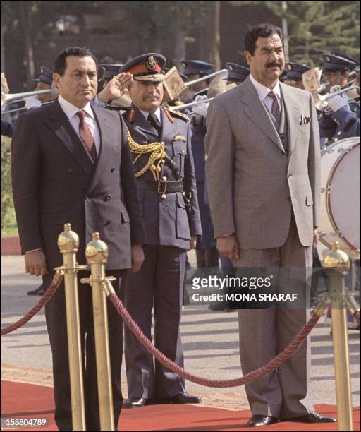 Iraqi President Saddam Hussein and Egyptian President Hosni Mubarak 28 January 1990 in Cairo reviewing the honor guard following Saddam's arrival in...