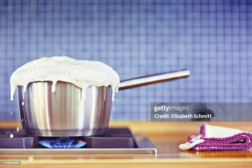Milk boiling over in pan