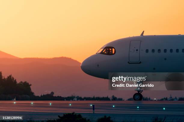 side view of aircraft cabin on its way to the takeoff runway, close-up of aircraft cabin in the moments before takeoff - jet tarmac stock pictures, royalty-free photos & images