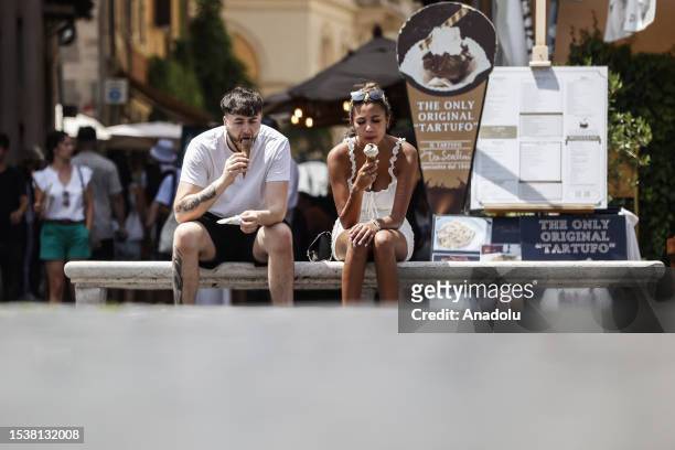 Tourists eat gelato during a sultry day in Piazza Navona, Rome, Italy, on July 17, 2023. Rome, Bologna and Florence are among the 16 Italian cities...