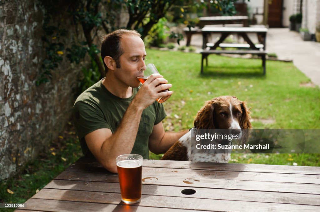 Man with dog in pub garden