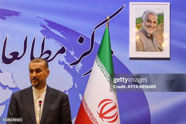 Framed portrait of the slain head of Iran's Islamic Revolutionary Guard Corps 's "Quds Force" Qasem Soleimani hangs behind Iran's Foreign Minister...