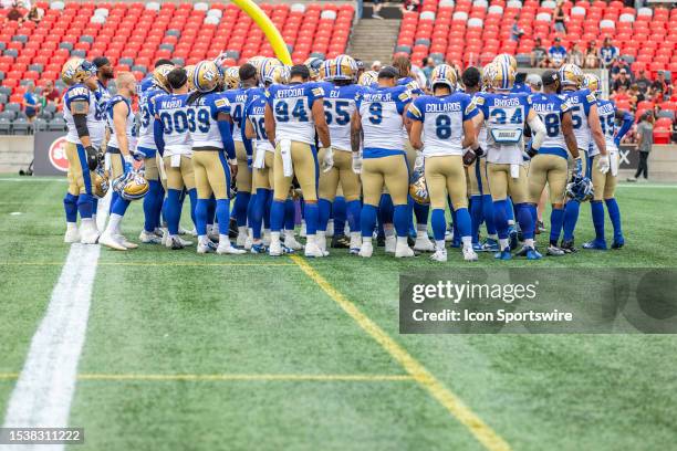 Winnipeg Blue Bombers huddle during warm-up before Canadian Football League action between the Winnipeg Blue Bombers and Ottawa Redblacks on July 15...