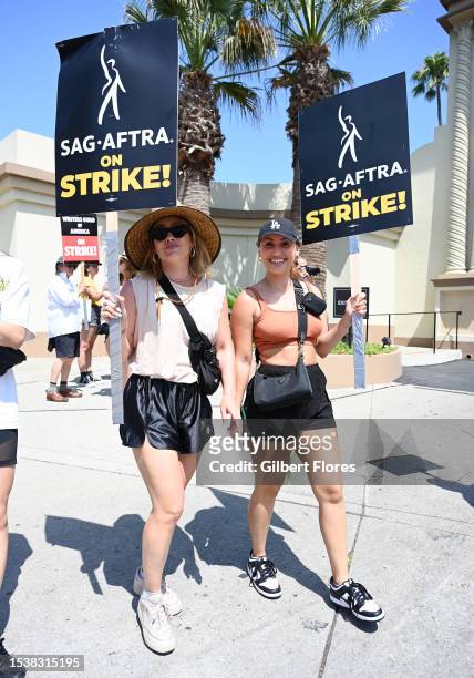 Hilary Duff and Francia Raisa walk the picket line on Day 5 in support of the SAG-AFTRA and WGA strike at Paramount Pictures Studio on July 17, 2023...