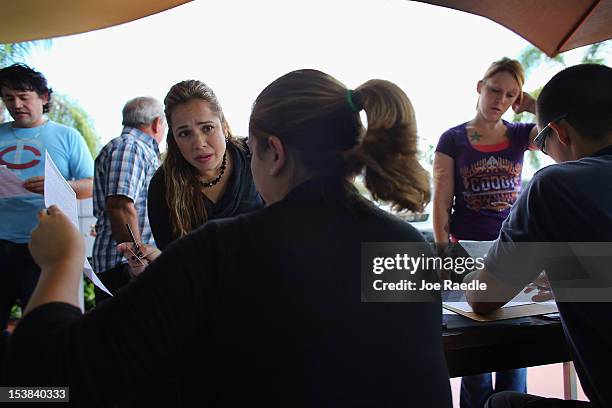 People deliver their voter registration forms to Miami-Dade Elections Department officials on the final day for voters to register to vote in the...