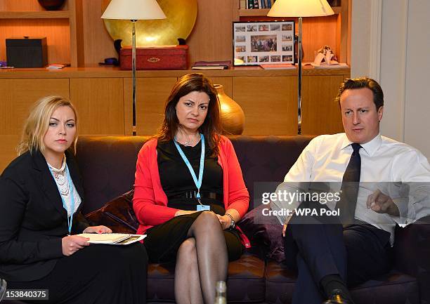 British Prime Minister David Cameron listens to singer Charlotte Church and former police officer Jacqui Hames during a private meeting at the...
