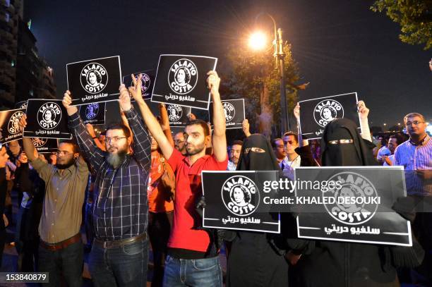 Egyptian Muslims from a group called "Salafyo Costa'' take part in a march in front of state television building in Cairo in Cairo on October 9, 2012...