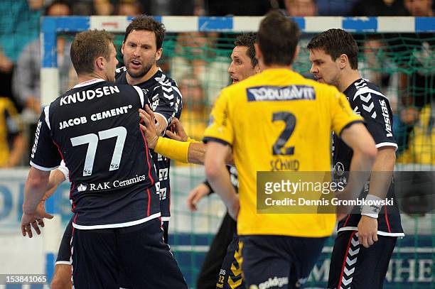 Michael Knudsen of Flensburg Handewitt and Zarko Sesum of Rhein Neckar Loewen argue during the DKB Handball Bundesliga match between Rhein Neckar...