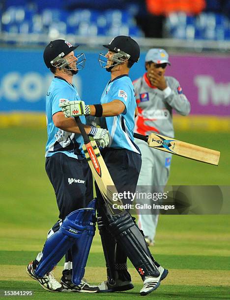 Colin Munro and Anaru Kitchen of Auckland celebrate the win during the Karbonn Smart CLT20 pre-tournament Qualifying Stage match between Sialkot...