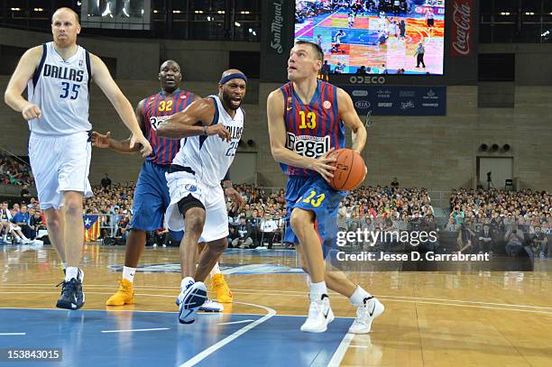 Sarunas Jasikevicius of F.C. Barcelona Regal drives against Vince Carter of the Dallas Mavericks during the game at Palau St. Jordi for NBA Europe...