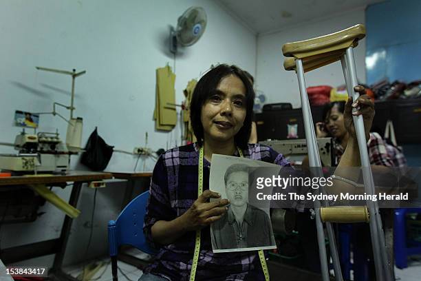 Endang Isnanik holds a photograph of her husband, Aris Munandar, who died in the 2002 Bali bombings, September 25 2012. Endang and four other widows...