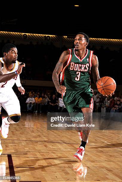 Brandon Jennings of the Milwaukee Bucks drives to the basket against Kyrie Irving of the Cleveland Cavaliers at The Canton Memorial Civic Center on...