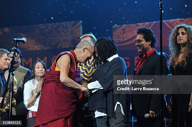His Holiness the Dalai Lama speaks with Whoopi Goldberg and Andy Madadian onstage at the One World Concert at Syracuse University on October 9, 2012...