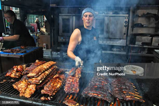 Barbequer cooks racks of ribs during the Toronto Ribfest in Toronto, Ontario, Canada, on July 16, 2023. The three-day meat-lover's festival is...