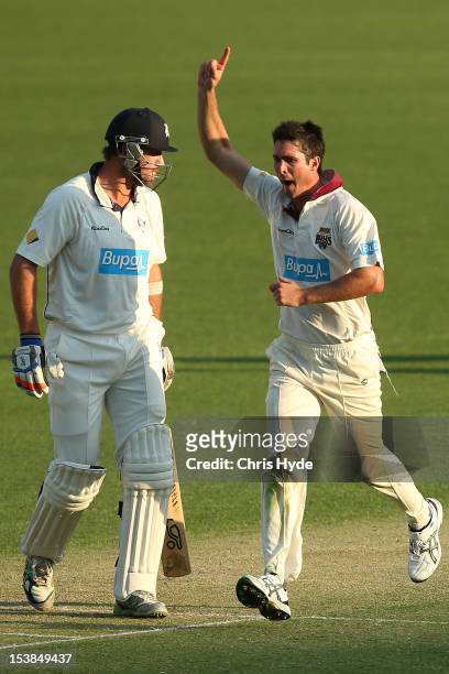 Ben Cutting of the Bulls celebrates after dismissing John Hastings of the Bushrangers as he looks on during day one of the Sheffield Shield match...
