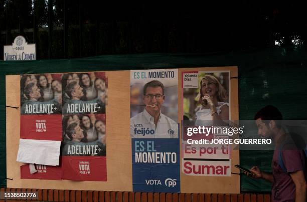 Man walks past electoral posters in Ronda, in Spain's southern Andalusia region, on July 17, 2023 ahead of July 23 general elections.