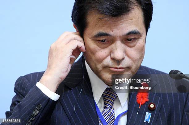 Koriki Jojima, Japan's finance minister, listens during a joint news conference with Jim Yong Kim, president of the World Bank Group, unseen, at the...