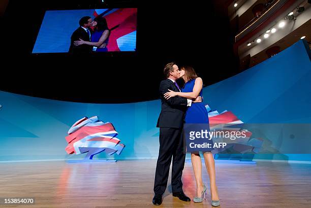 British Prime Minister David Cameron kisses his wife Samantha onstage after making his keynote address on the fourth day of the annual Conservative...