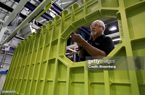 An employee works on a component for an Airbus SAS aircraft, a unit of European Aeronautic, Defence & Space Co. , at GKN Plc's Aerospace factory in...