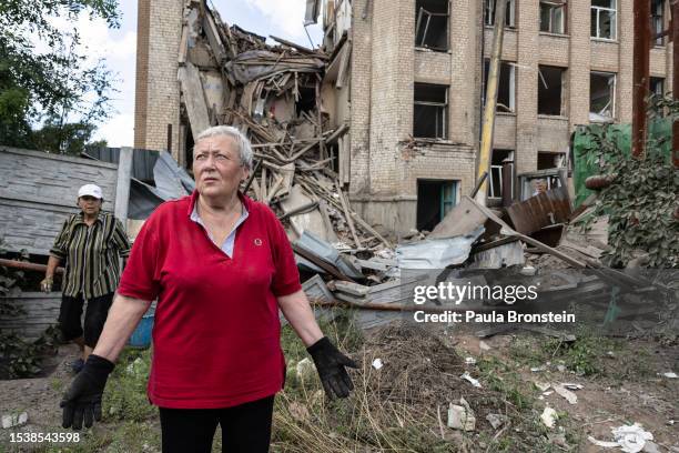 Lubov helps clear debris after the overnight rocket attack of School number 16 which was empty at the time of the attack on July 17, 2023 in...